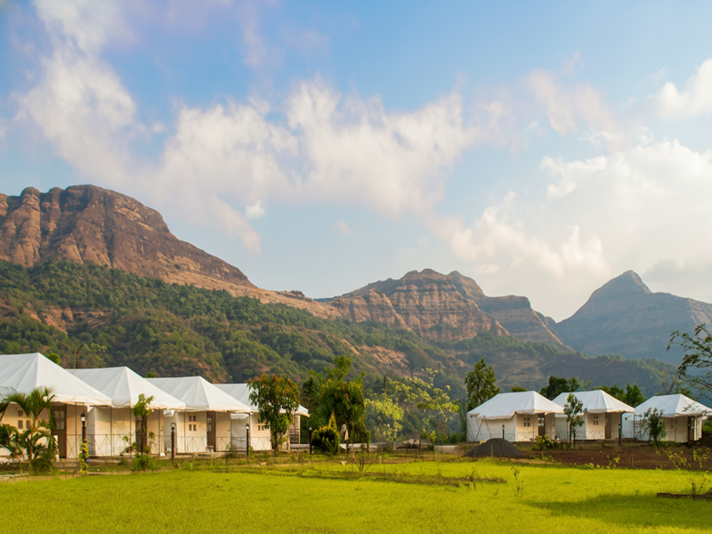 Traveler enjoying a digital detox near Arthur Lake at Necklace Hill View Resort — the Best Resort in Bhandardara.