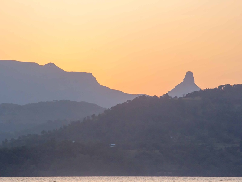 Beautiful sunrise over the hills and lake in Bhandardara