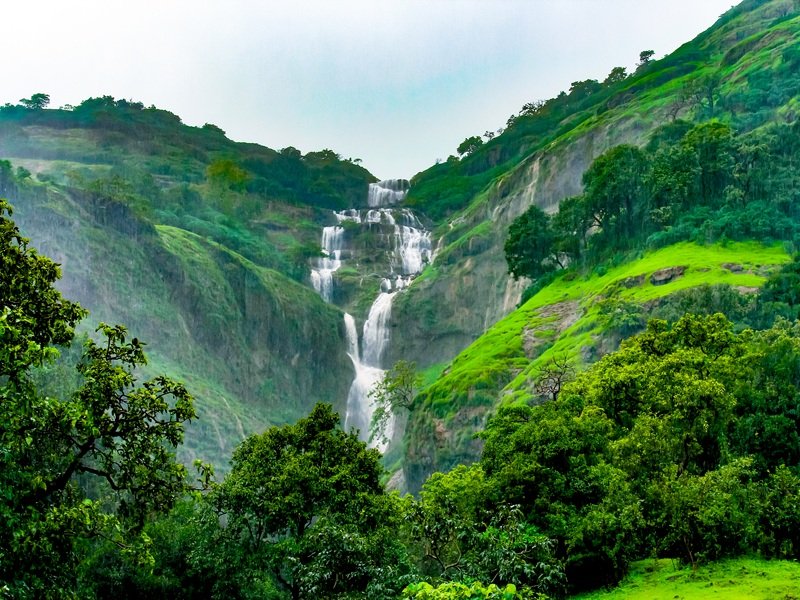 Family trekking through the scenic hills of Bhandardara