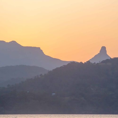 Beautiful sunrise over the hills and lake in Bhandardara
